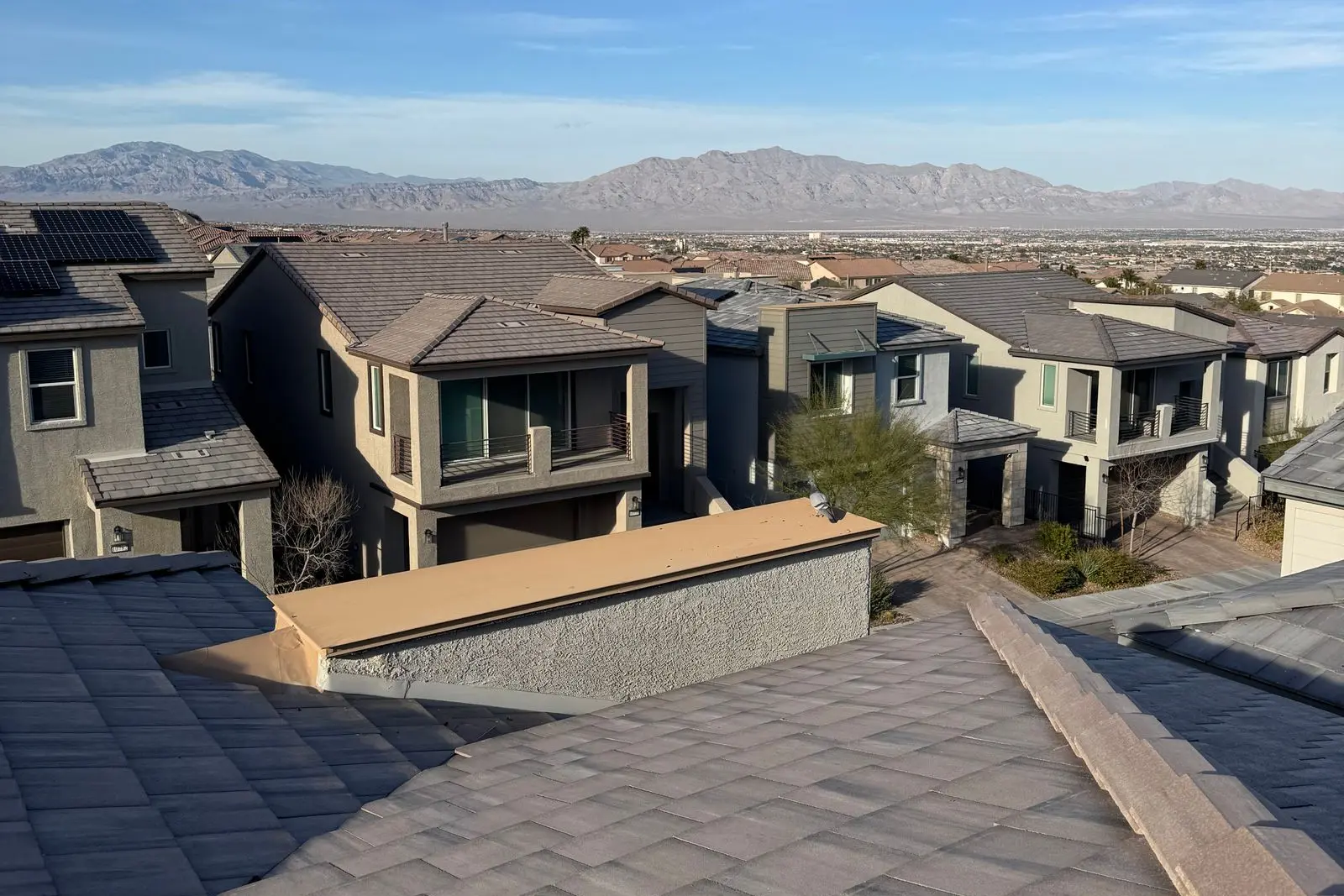 Tile rooftops of a Las Vegas suburb with mountains behind